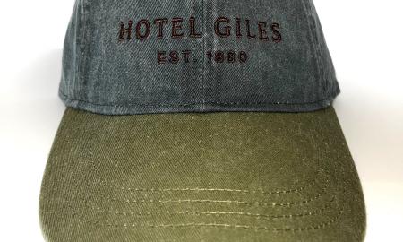 Two-tone fabric adjustable cap with tan embroidered Hotel Giles logo