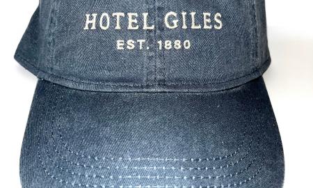 Blue fabric adjustable cap with cream embroidered Hotel Giles logo